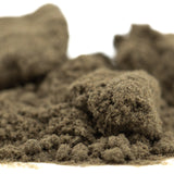 Tangelo THCa Kief showing light brown finely ground powder with clumps, ideal for hemp flower use