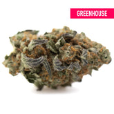 A dense green and orange astroboy greenhouse thca hemp flower bud with frosty textured surface and high thca concentration