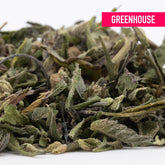 A pile of dried light green and pale yellow bahama bussdown greenhouse thca hemp flower trim with a fuzzy texture