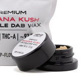 Black cylindrical container with white label holding 5 gram banana kush thca crumble wax hemp flower concentrate