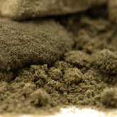 A mound of finely ground green thca kief with a tropical character from legendary banana og full-term wholesale