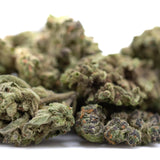 Lush dense banjerine thca flower smalls with green and purple hues and fine trichomes ultra-premium citrus indica