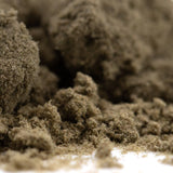 Clumpy textured brown banjerine thca kief with coarse granular surface highlighting paradoxical citrus wholesale positioning