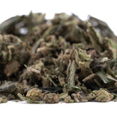 A pile of dried blueberry muffin thca trim hemp flower buds with green and brown hues for wholesale use