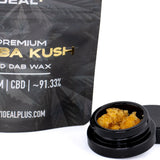 Black cylindrical container holding golden-orange crystalline bubba kush 91.33% cbd dab wax 1g for pre-98 bubba kush