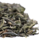A pile of dried muted green and grayish sage leaves in candy pave greenhouse thca trim wholesale product form