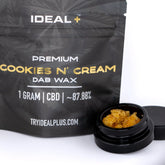 Black pouch of ideal plus premium cookies and cream cbd dab wax with 1 gram amber dab wax in black jar