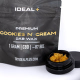 Black pouch of ideal plus premium cookies and cream cbd dab wax with 1 gram amber dab wax in black jar