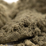 A mound of coarse beige cream caramel thca kief showcasing textured hemp flower product material