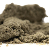 A mound of fine textured thca kief in muted olive green from cream caramel kief hemp flower product