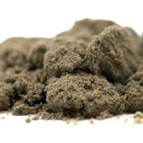 A mound of fine textured cream caramel thca kief in muted olive green from hemp flower product full-term