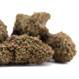 Bud of critical berries cbd full-term hemp flower with dense textured surface in green and brown tones and terpene profile hints of bubba kush