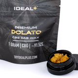 Black pouch of ideal plus dolato cbg dab wax with gold lettering and black jar of amber 91.52 percent cbg wax 1g