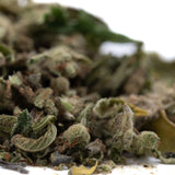 A pile of durban poison pure sativa thca trim with frosty trichomes and green leaves in full-term wholesale packaging