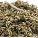 A pile of early blossom full-term cbd trim hemp flower buds in green brown and beige hues for auto tsunami use