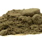A mound of fine earthy green thca kief full-term from dark heart nursery sour lemon-lime strain with granular texture