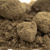 Brown THCa kief chunks from Face Gas hemp flower, matte clay texture