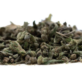 A pile of dried greenish gray fog dog trim thca hemp flower with a textured slightly fuzzy surface