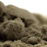 A mound of coarse beige fog dog kief showcasing the concentrated potency of hemp flower texture