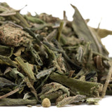 A pile of dried white tea leaves in pale green and brown hues for fornicate greenhouse thca trim wholesale