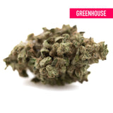A dense greenish-brown fornicator thca hemp flower bud with trichomes from greenhouse hemp cultivation practices