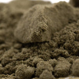 A mound of dark gray thca kief with fine-grained clumpy texture for therapeutic mood enhancement from hemp flower