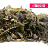 A pile of dried green and brown gas monkey greenhouse thca trim hemp flower leaves with stems for wholesale use