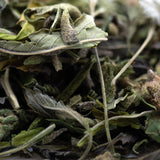 Dried sage leaves with muted green hue and fuzzy texture in giggle gas greenhouse thca trim wholesale hemp flower pile