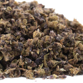 A pile of dried glue full-term cbd trim hemp flower trim with green brown and purple hues
