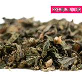 Dried green herbs with brown pieces for Hooch Indoor THCa Trim Wholesale 1LB, purple city genetics, rich trichome coverage