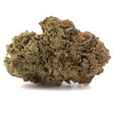 A dense irregular jokerz nos thca flower bud with green and orange trichomes resembling jet fuel and white runtz