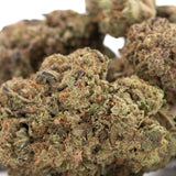 A dense resinous jokerz nos thca hemp flower with green and orange hues featuring near-maximum potency