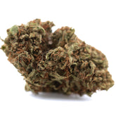 Dense irregular lemon octane cbd hemp flower bud with green brown hues and fine trichomes similar to bubba kush