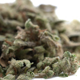 A dense green mega gummie bearz thca trim hemp flower bud with trichomes and brown pistils for wholesale use