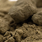 Clumpy textured beige kief from mega gummie bearz thca hemp flower with enhanced cbd for wholesale use