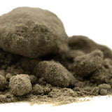 A mound of coarse grayish-brown thca kief with a gritty texture from mendo breath cult classic full-term product