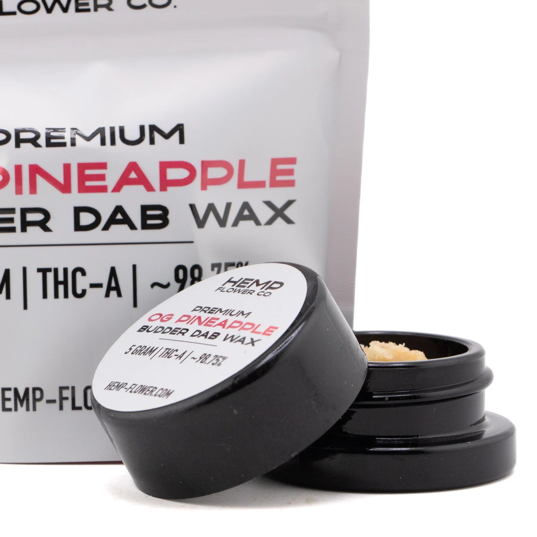 Black cylindrical container with white label holding light-colored crumbly thca budder wax from pineapple og hemp flower