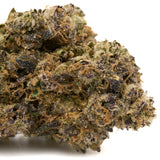 Close-up of Pineapple Rainbow’s THCA Flower with purple hues, orange pistils, and white trichomes