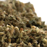 A dense pivot full-term cbd hemp flower trim with green and brown hues covered in fine trichomes and high cbd content