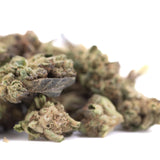 A pile of poison gushers thca hemp flower greenhouse smalls with green brown and purple dried buds