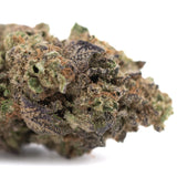 A dense rozay cake hemp flower with green brown and purple hues covered in trichomes from greenhouse cultivation