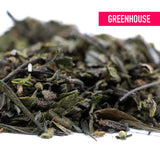 A pile of dried green tea leaves in dark and light shades showcasing the premium greenhouse purple marmalade trim with terpene profile