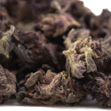 Purple queens thca smalls hemp flower with frosty purple and green buds featuring a textured surface