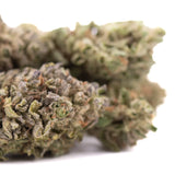 A dense green rozay cake hemp flower with frosty white trichomes and hints of purple and orange pistils wedding cake strain
