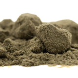 A mound of fine olive-green thca kief from legendary sour diesel hemp flower in sour apple full-term blend