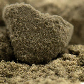 A textured earthy-brown thca kief rock with a rough fibrous surface from legendary genetics sour diesel full-term wholesale