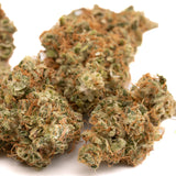 Green and orange-hued sour brûlée cbd smalls flower with dense frosty texture and rich terpene profile for wholesale use
