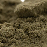 A close-up of coarse greenish-brown sour diesel thca kief with gritty texture for legendary fuel mexican sativa use