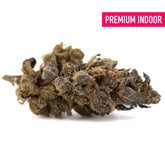 A dense space candy candy indoor thca flower bud with green and dark brown hues covered in frosty trichomes