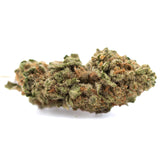 A dense green and orange-hued sugar thca greenhouse smallts bud covered in trichomes with textured surface